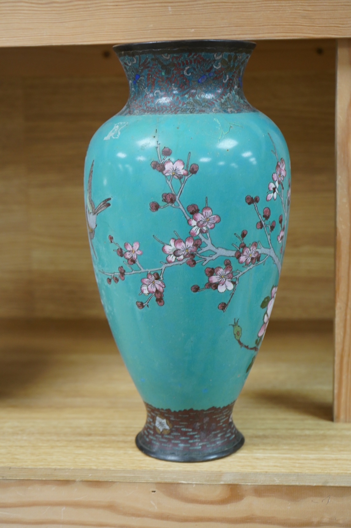 A Japanese cloisonne vase enamelled with birds amongst blossom, 31cm high